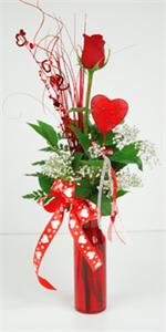 Show your favorite valentine that they are number one by sending our “Cross my Heart” vase. This classic ruby red glass vase is filled with one red rose with mixed greenery, and red heart, matching red heart grass, baby breath, and tied with valentine rib