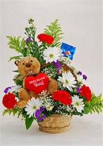 Send the rally squirrel to convey your Valentine's Day message. Arranged in a wicker basket with red carnations,white spray daisies, purple statice, yellow solidago, million star gyp and mixed greens And to make sure they get the point our rally  