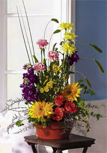 Yellow Mums, Orange Roses, Sunflowers, Carnations, & Pompons With Garden Saucer Dish