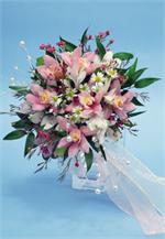 Pink cymbidium orchid with pink wax flower, Italian ruscus, and tied with white wired ribbons.