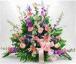 Designed with lavender larkspur, pink carnations, pink star grazers lilies, purple stock, baby blue iris, mixed greens and million star baby breath and matching pink bow. Flowers help to convey our thoughts when words fail us. Our “Celestial Garden” say t