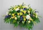 Our Comforting Garden is a casket piece designed with vibrant colored flowers to celebrate a life filled with joy, compassion and love. Designed with white mums, white snapdragons, yellow Asiatic lilies, green hydrangeas, yellow roses, yellow button chrys