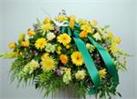 Designed with yellow spider mums, golden yellow roses, yellow button pomps, with yellow snapdragons, mixed greenery and trimed with emerald green ribbons.