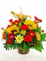 Fall pail arrangement filled with the colors of the autumn season. Orange asiatic lillies with red roses, deep purple spray dasies, golden yellow solidago, deep blue statice, hypericum berries, mixed greens and stems of wheat. Enjoy all of the fall treasu