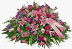 Our Halo of Memories casket piece is made with pink stargazer lilies pink carnations, pink roses, lavender daisies, purple liatris, with purple statics, baby breath and mixed greens. This is a full side casket arrangement. A choice of script is included.
