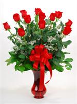 It will be all romance this Valentine's Day when you send the Romance and Roses Bouquet. One dozen long stem red roses arranged in a Valentine Red Vase with baby breath, mixed greenery and matching ribbons. You gift will arrive on time and ready to enjoy.