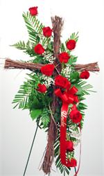 One dozed roses are arranged on a natural 30” grape vine cross with mixed greens and million star gyp and displayed on a 54” easel. Other colors are also available. Also included is your choice of script.