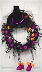 There's no trick in this Halloween treat! Our witches wreath comes complete with her hat and shoes. This wreath is decked out in purple and orange,and  and sprinkled with glittery grinning pumpkins. Welcome all the goblins that visit your home this festiv